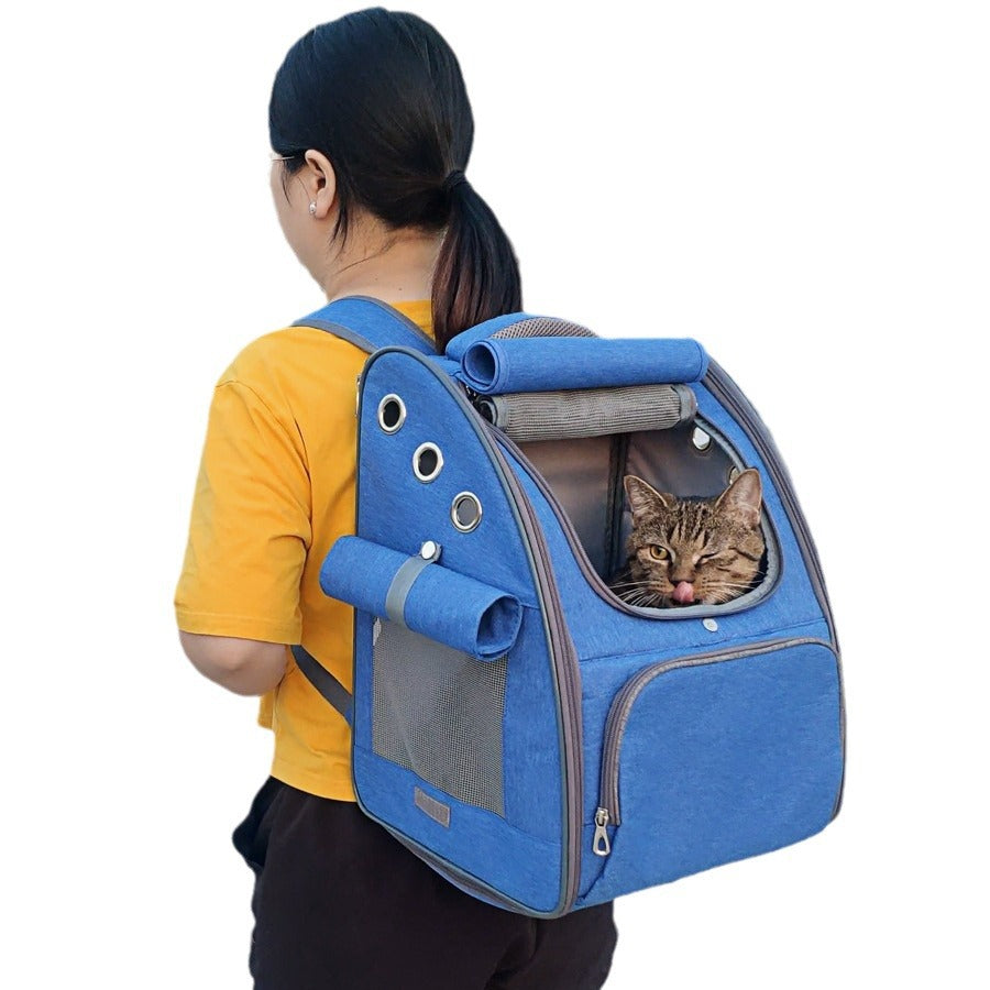 Blue dog backpack carrier showing a happy cat sticking out its tongue, ideal for traveling with pets.